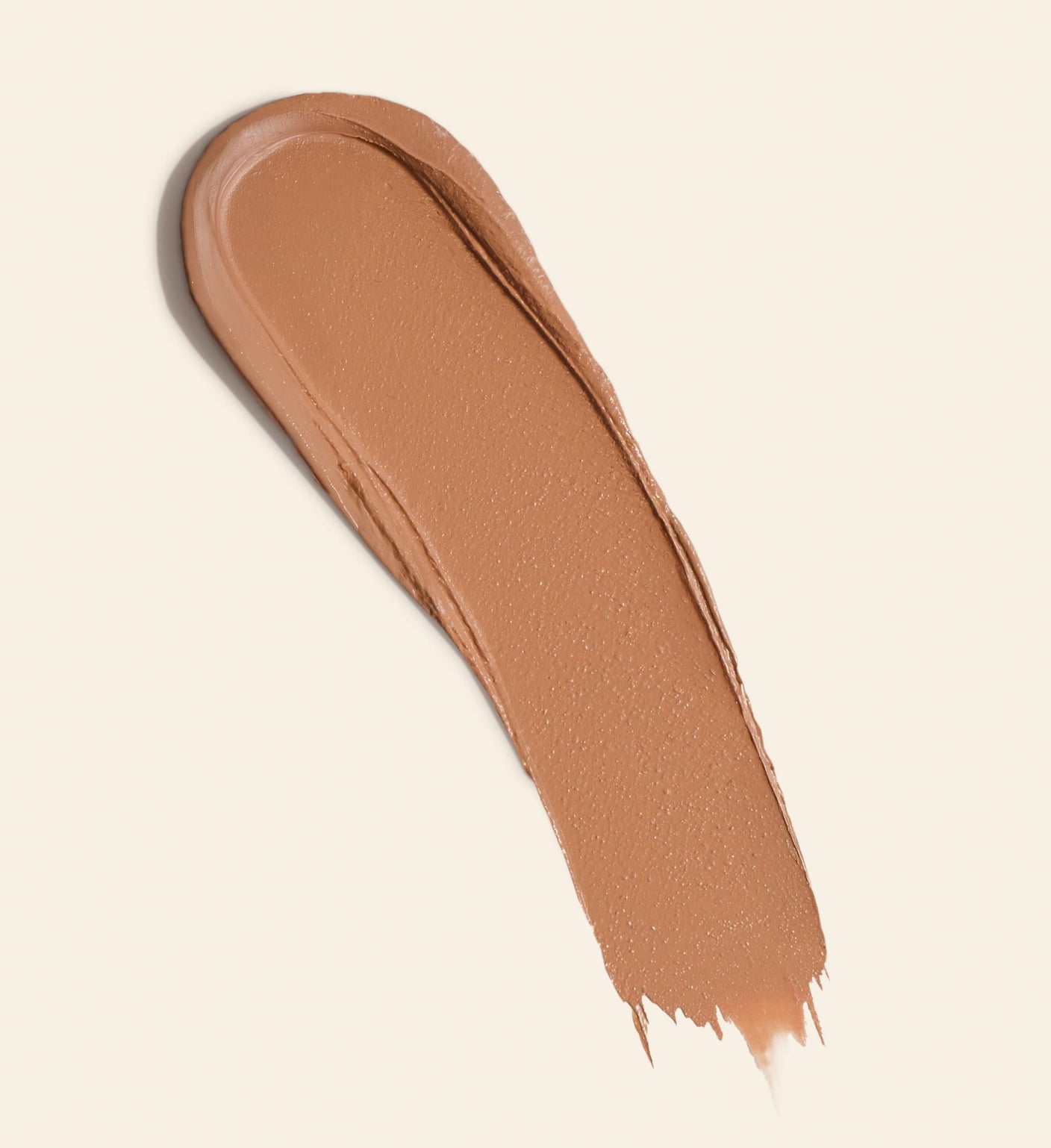 Soft Tan Bronzer Swatch in Light zeigt die cremige, aufbaubare Formel für einen natürlichen Glow.
